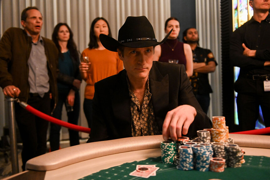 Hank Riddle (Stew McLean) sits at a poker table