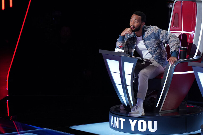 John Legend sits during Season 24, Episode 6 of the Voice