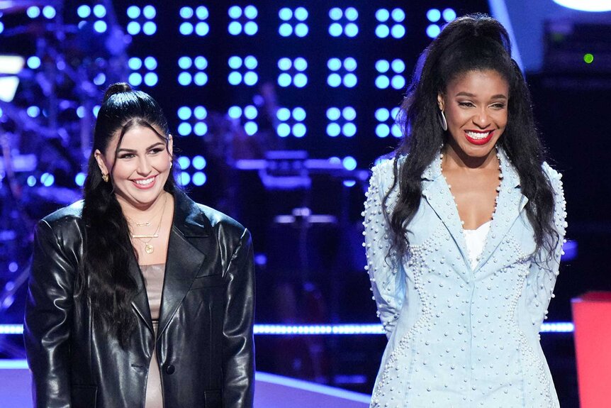 Chechi Sarai and Calla Prejean stand on stage during The Voice episode 2410