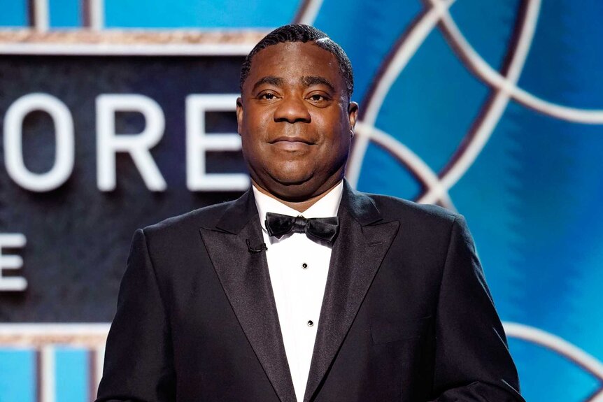 Tracy Morgan, wearing a black suit with a bowtie, on stage at the 78th Annual Golden Globe Awards.