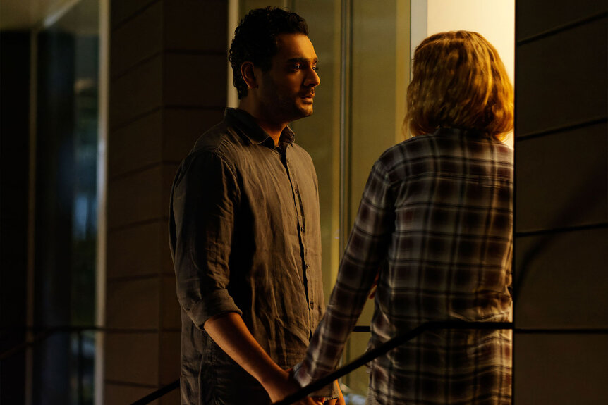 Dr. Bashir stands in a doorway with Mags