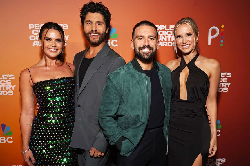 Abby Law, Dan Smyers, Shay Mooney, and Hannah Billingsley posing and smiling together on the red carpet.