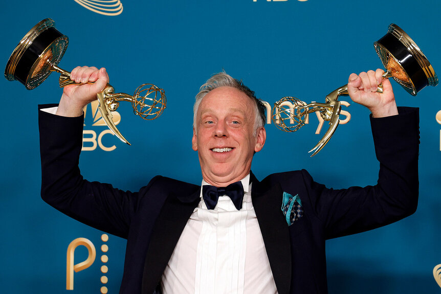 Mike White holds his two Emmy awards up