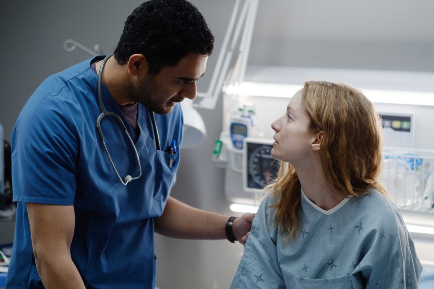 Dr. Bashir Hamed looking down at Dr. Magalie Leblanc.