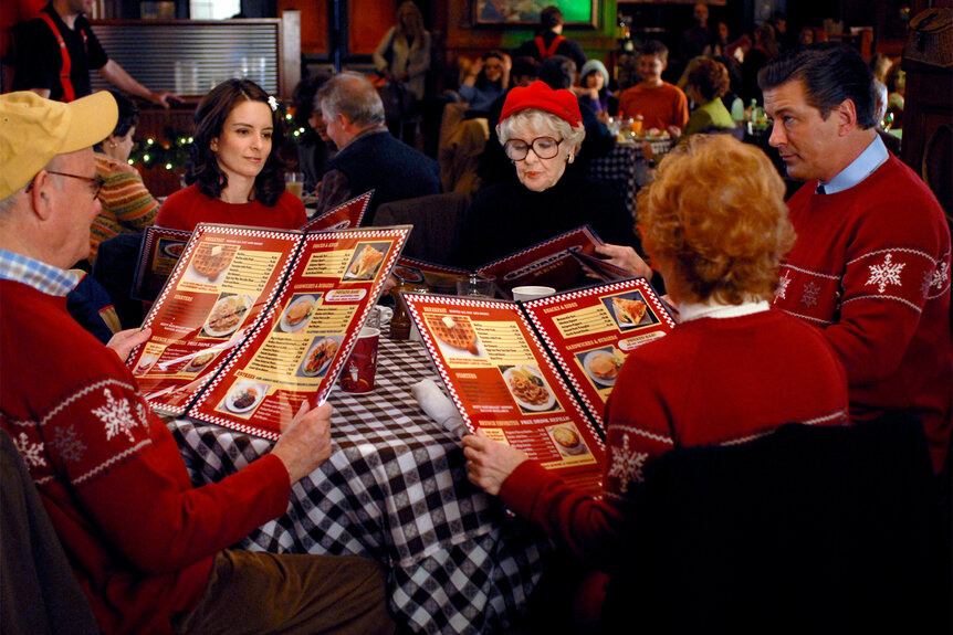 the cast of 30 rock sit together at a table looking at menus during episode 209