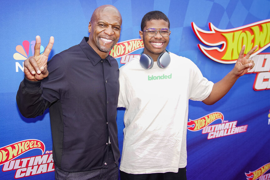 Terry Crews and Isaiah Crews pose together on the Hot Wheels: Ultimate Challenge press event red carpet