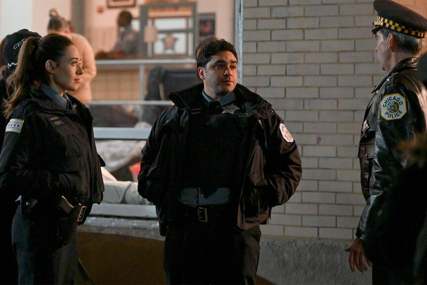 Kim Burgess and Danny Alvarado talk to a cop in Chicago PD 1103