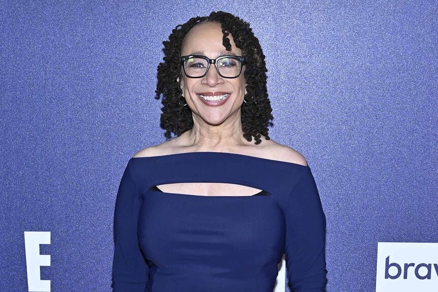 S. Epatha Merkerson smiles in a blue dress.