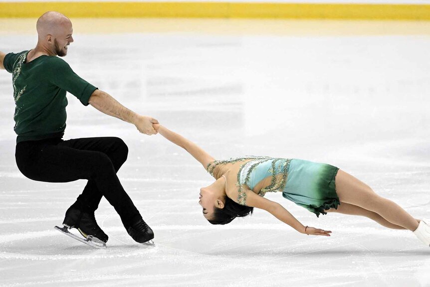 Danny O'Shea holds out Ellie Kam while dancing on ice.