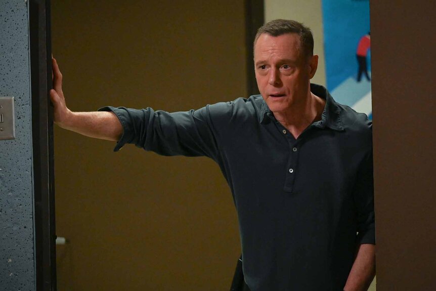 Hank Voight leans in a doorway on Chicago P.D. Season 11 Episode 1.