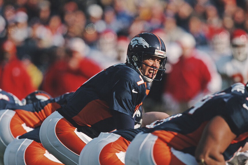 John Elway #7, Quarterback for the Denver Broncos calls the play on the line of scrimmage during the American Football Conference West game against the Kansas City Chiefs