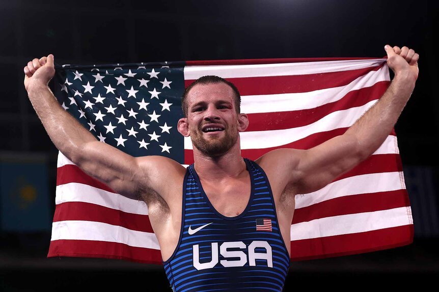 David Morris Taylor III holds up an American Flag.