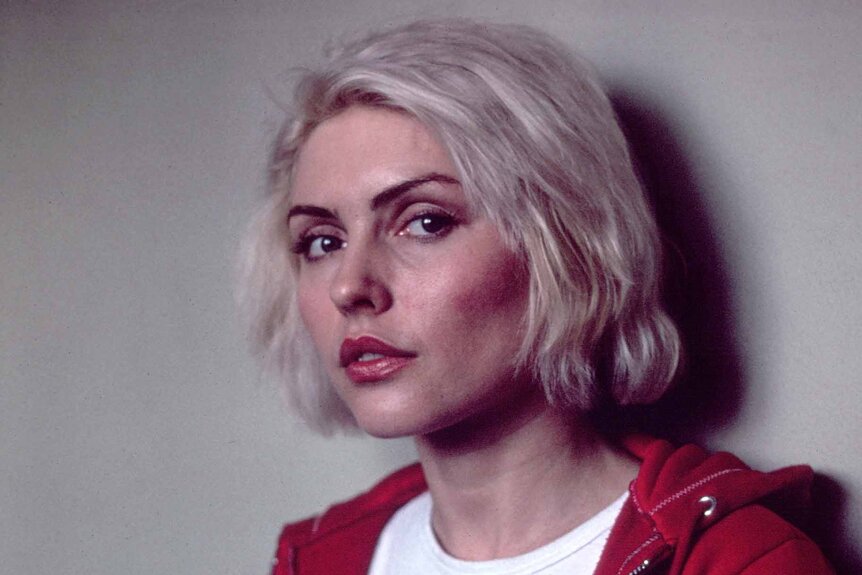 Debbie Harry wears a red hoodie.