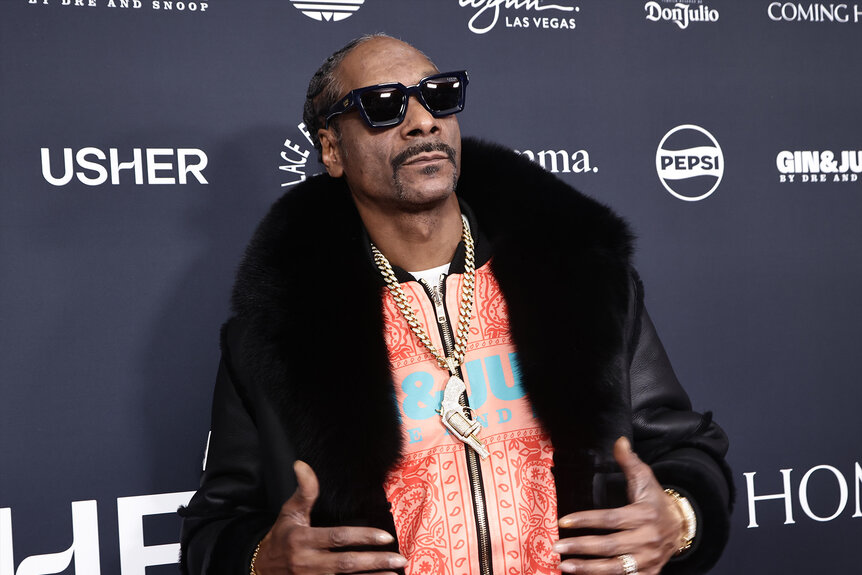 Snoop Dogg poses in sunglasses and a fur coat.