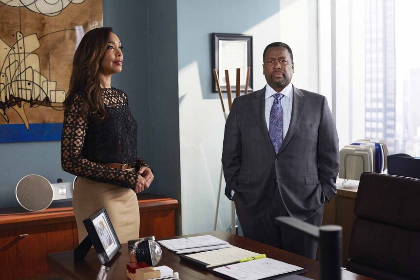 Jessica Pearson and Robert Zane stand in an office in Suits Episode 504.