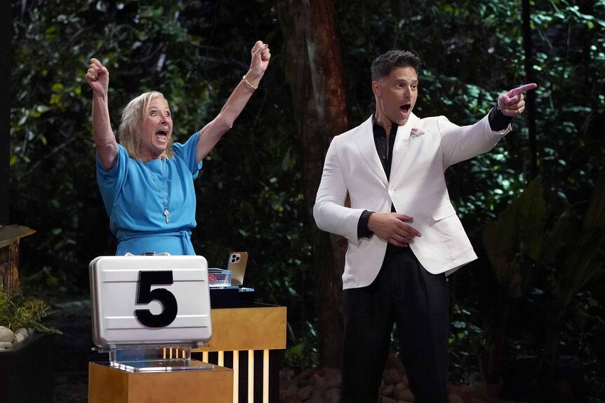 Kim Mattina cheers as Joe Manganiello points in Deal or No Deal Island Episode 102.