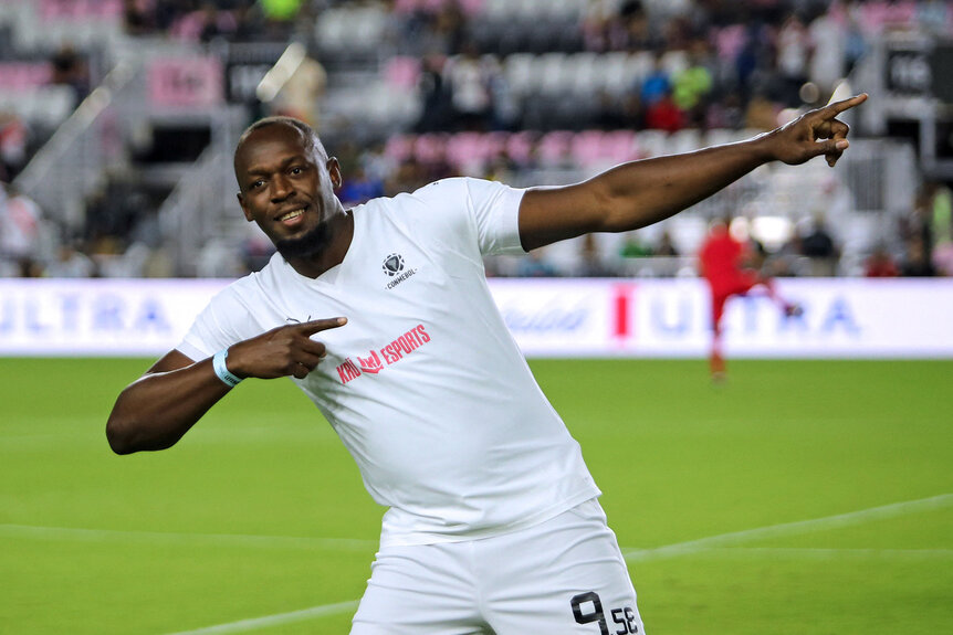 Usain Bolt gestures before the exhibition "Leyendas Conmebol" football match at DRV PNK Stadium