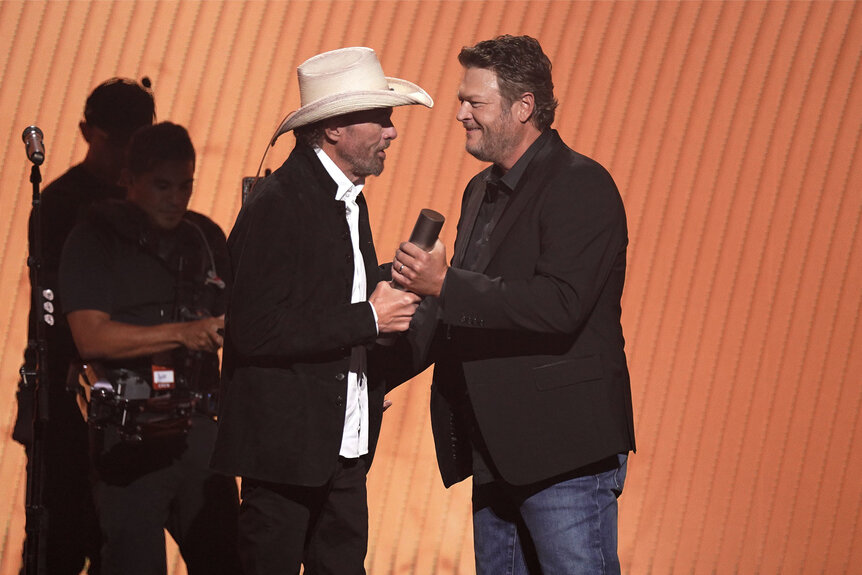 Honoree Toby Keith accepts the Country Icon award from Blake Shelton on stage during the 2023 People's Choice Country Awards