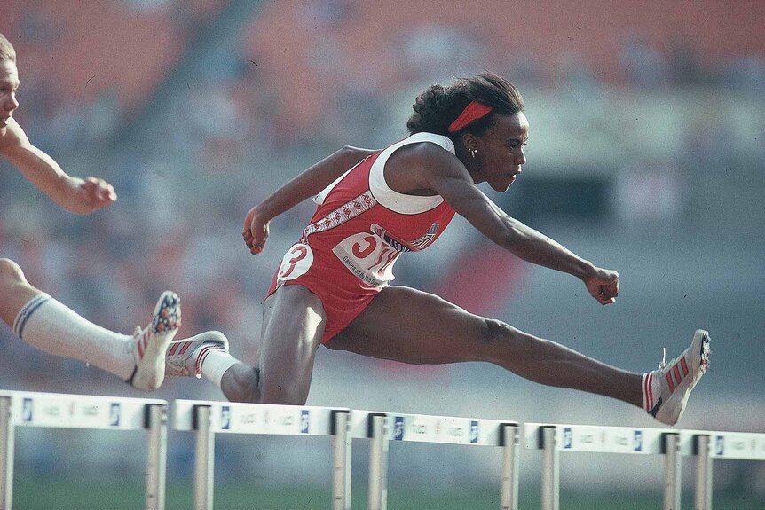 Jackie Joyner-Kerse jumps a hurdle.