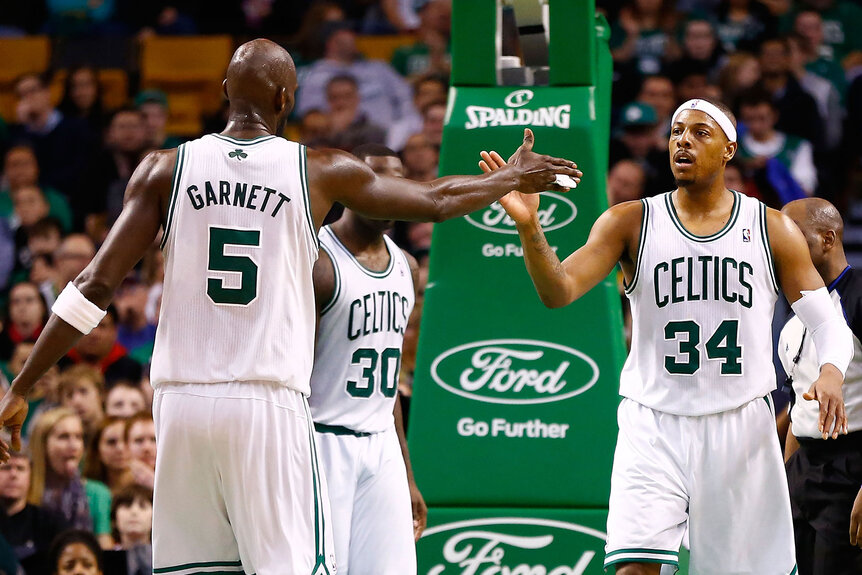 Kevin Garnett congratulates teammate Paul Pierce during the game against the Sacramento Kings on January 30, 2013 at TD Garden in Boston, Massachusetts.