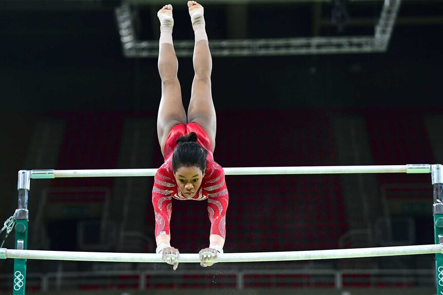 Gaby Douglas practices on the uneven bars at the Olympic Arena on August 4, 2016