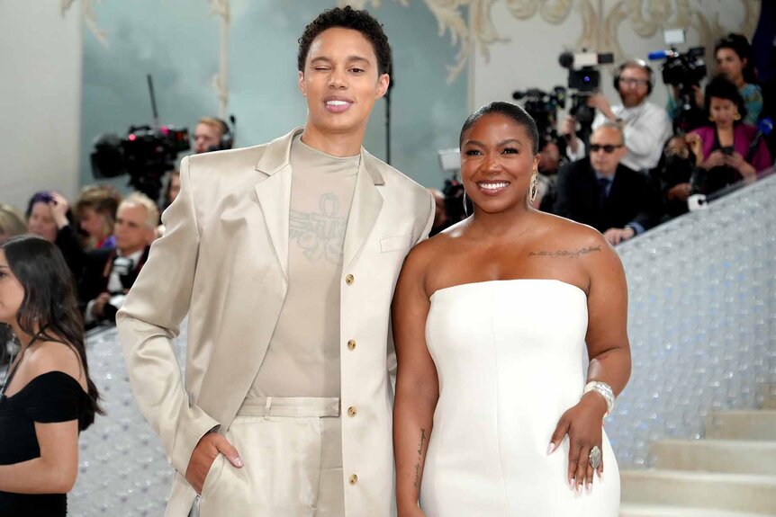 Brittney Griner and Cherelle Griner pose in match white outfits.