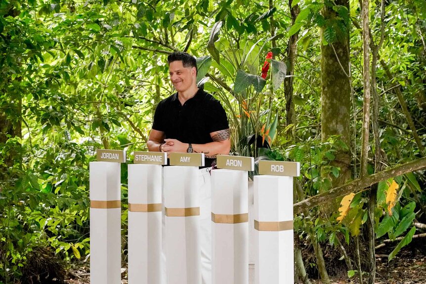 Joe Manganiello smiles outside in Deal or No Deal Island Episode 110.