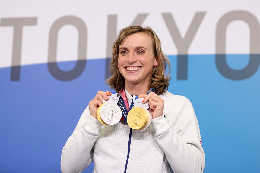 Katie Ledecky holds up her two Gold and two Silver medals