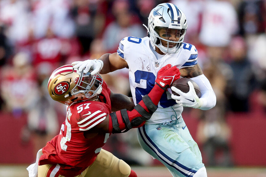 Tony Pollard #20 of the Dallas Cowboys carries the ball against Dre Greenlaw #57 of the San Francisco 49ers