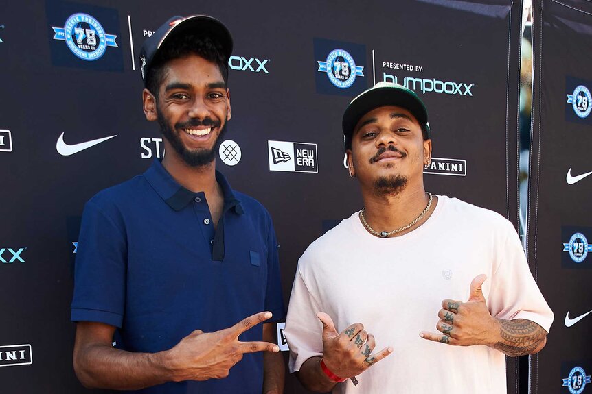 Julian and Corde Broadus smile on the red carpet for the Bumpboxx Honors 75th Anniversary Of Jackie Robinson