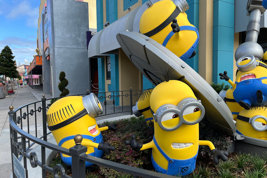 A statue of Minions building things at Minions Land