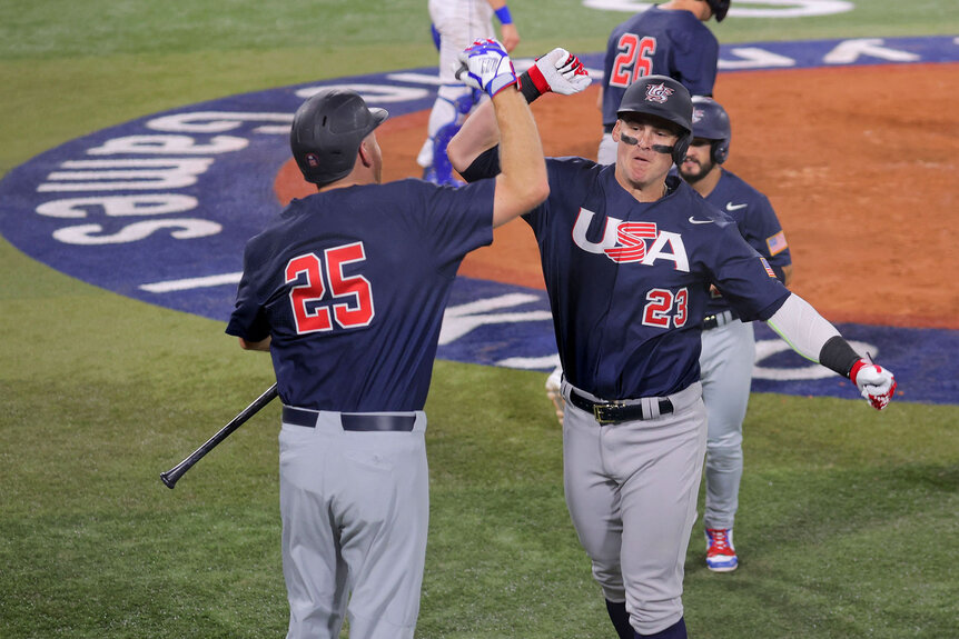 Christopher Austin is celebrated by Todd Frazier (L) on his two run home run