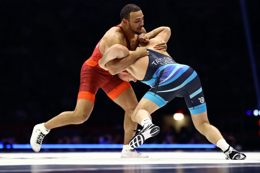 Aaron Brooks and David Taylor wrestle during a match