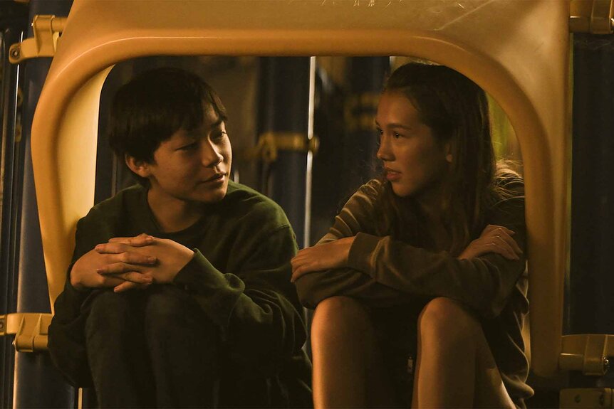 Chris Wang (Izaac Wang) and Madi (Mahaela Park) chat in a slide in Didi (2024).