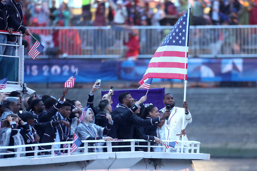 Lebron James and Coco Gauff hold the flag at the 2024 Olympics Opening Ceremony