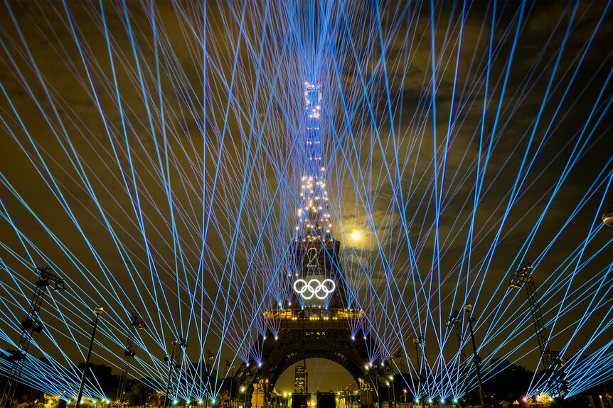 A light show happens in front of the Eiffel Tower ahead of the 2024 Olympics opening ceremony