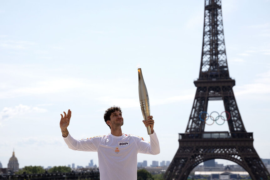 Torch bearer Matthias Dandois holds the Olympic Torch during the Paris 2024 Olympic Games Torch Relay