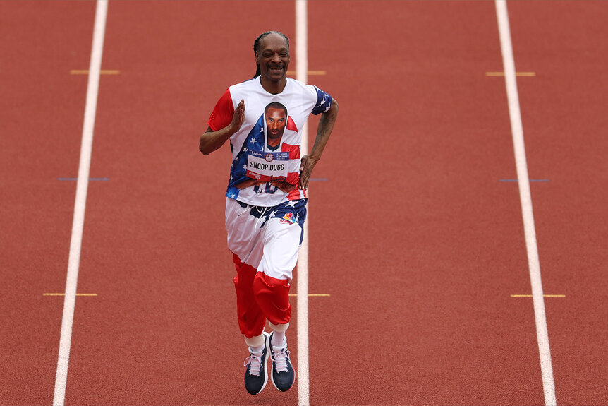 Snoop Dogg runs on the track with a custom bib number on Day Three 2024 U.S. Olympic Team Trials Track & Field