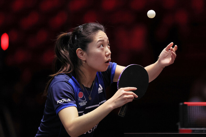 Lily Zhang of United States competes in the Women's Singles Round of 64 table tennis match against Miwa Harimoto of Japan