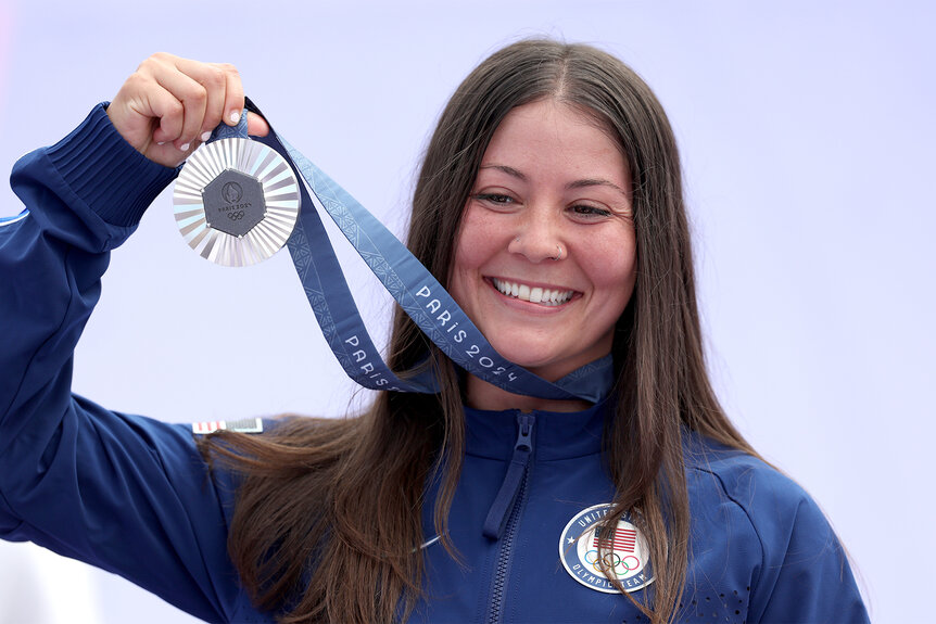 Perris Benegas holds her silver medal up and smiles after winning the BMX Freestyle at the 2024 olympics