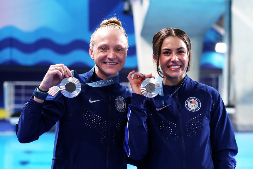 Sarah Bacon and Kassidy Cook hold up their silver medals at the Paris Olympics