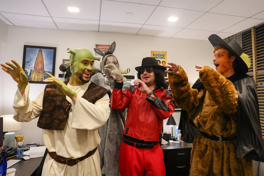 Bad Bunny dressed as shrek with other cast members of Saturday Night Live during a sketch