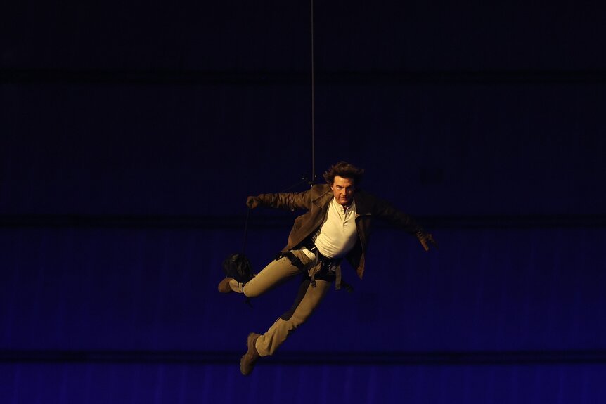 Tom Cruise rappels into the Stade de France during the Paris Olympics Closing Ceremony