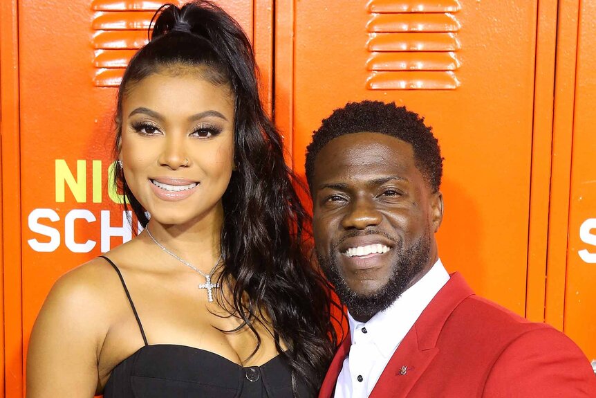 Eniko Parrish and Kevin Hart smile together at a premiere.