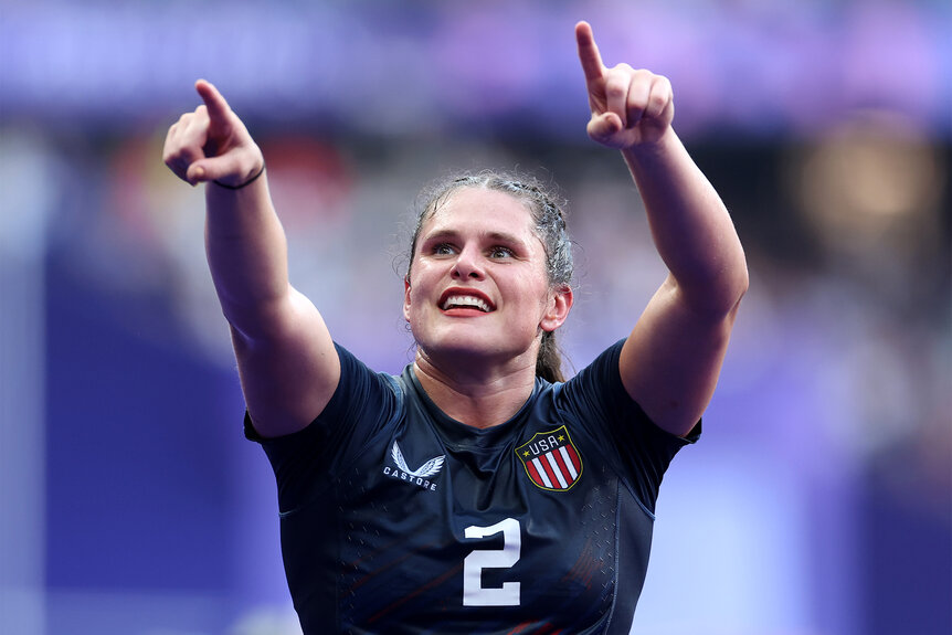 Ilona Maher points up to the crowd during a rugby match at the 2024 olympics