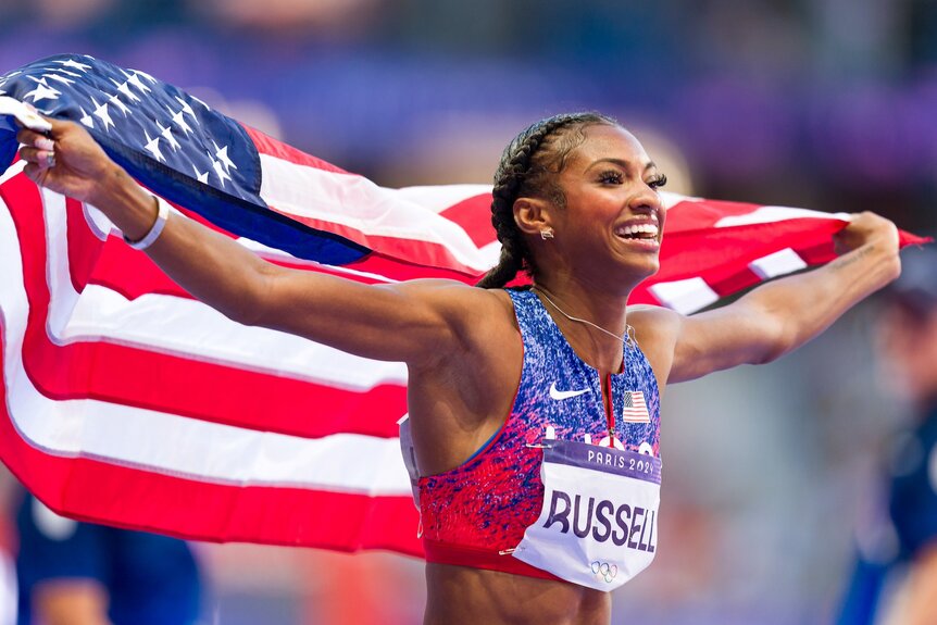 Masai Russell celebrates after winning gold at the 2024 Olympics