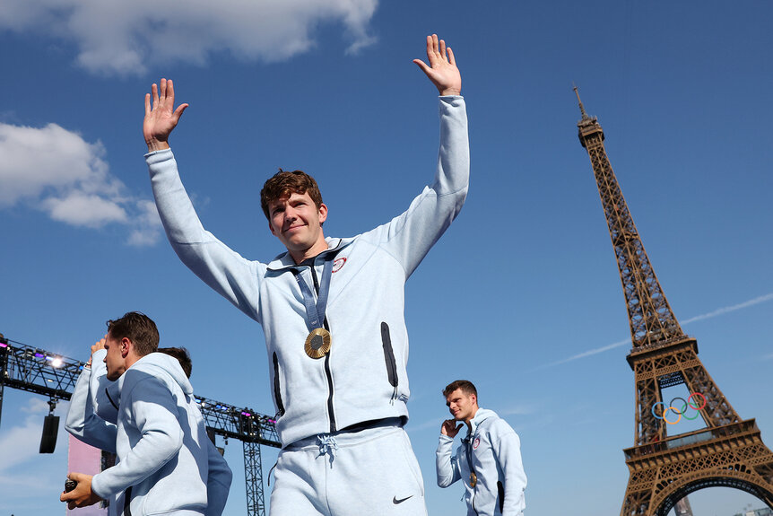 Nick Mead waves to the crowd while wearing his gold medal during the 2024 Olympics