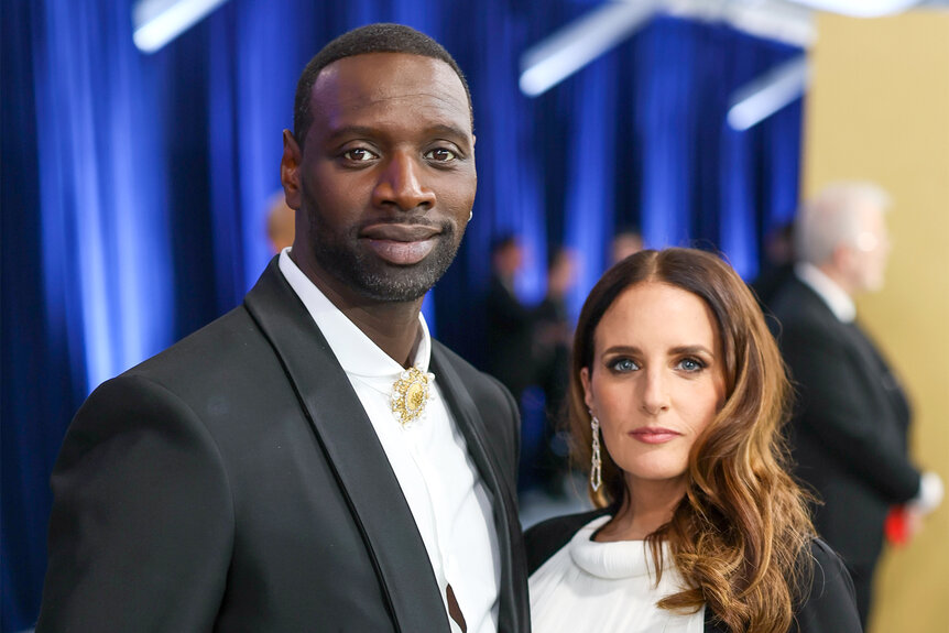 Omar Sy and Hélène Sy pose together on the red carpet