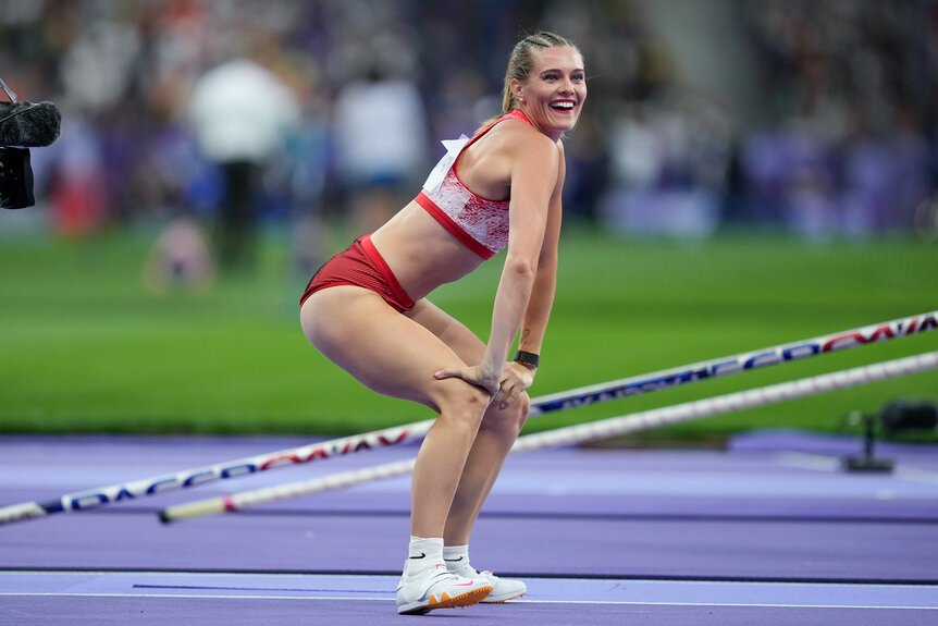 Alysha Newman celebrating after a successful pole vault at the Paris 2024 Olympics.