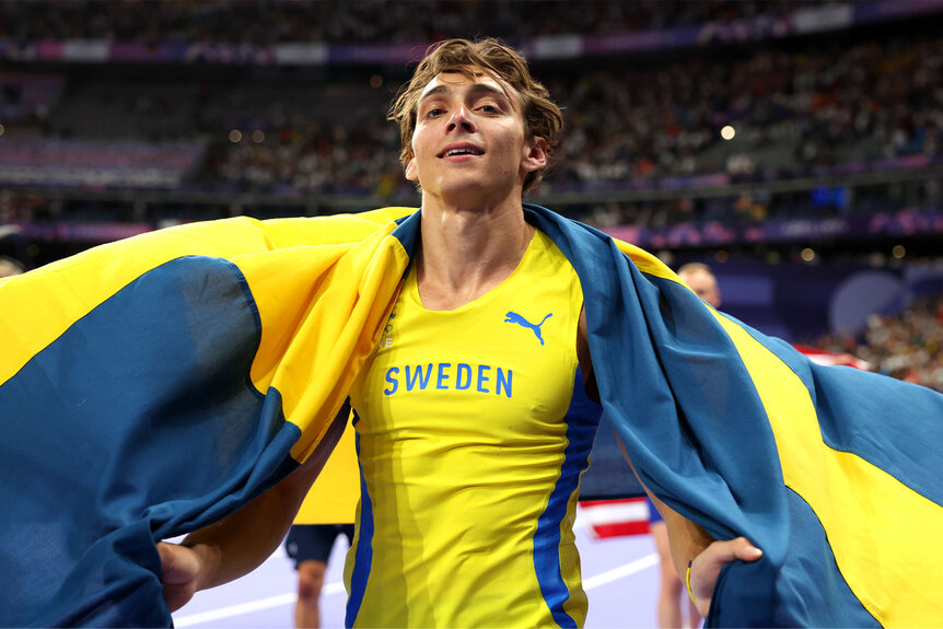 Armand Duplantis of Sweden celebrates after setting a new world record during the Men's Pole Vault Final at the Paris 2024 Olympics